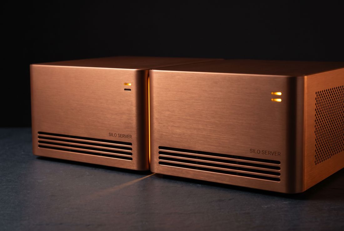 Two Silo Server modules joined side by side, warm light glowing from the vertical seam between them to indicate an active SiloLink-X fabric link